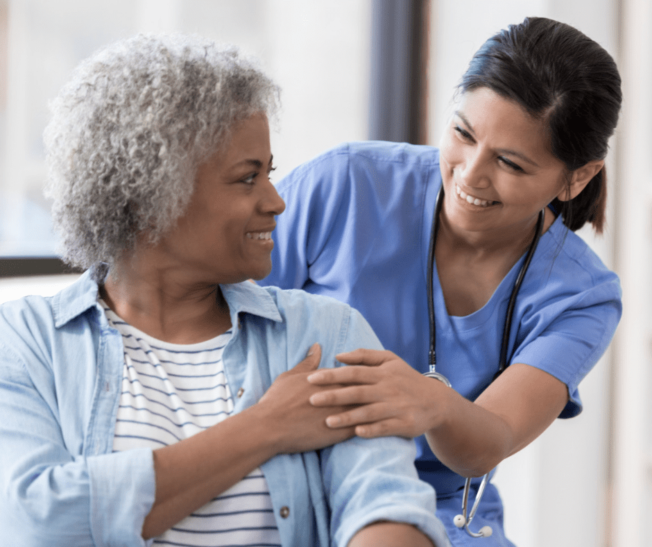 A nurse is hugging an older woman.