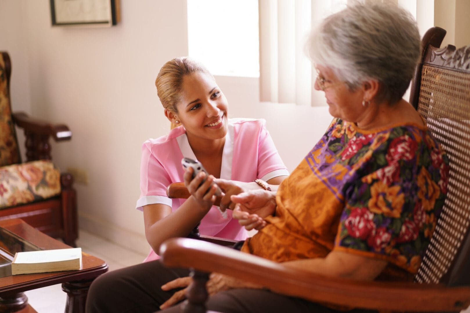 A woman and an older person sitting on the floor